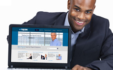 Photo of a young man showing a computer with the Apex Payroll website